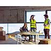 young team of business people in group, architect and engineer on construction site checking documents and business workflow using the virtual reality headset and laptop computer in new startup office