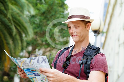 Happy young man with a map
