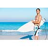 A young surfer with his board on the beach