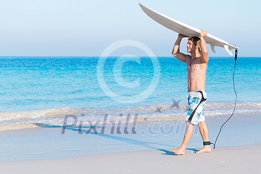 A young surfer with his board on the beach A young surfer with his board on the beach