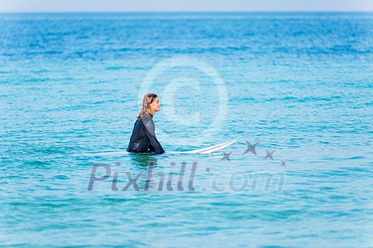 A young surfer with his board on the beach A young surfer with his board on the beach