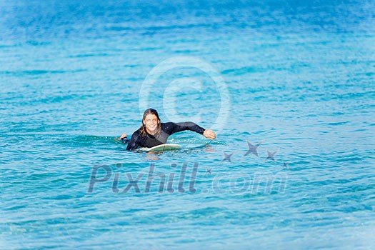 A young surfer with his board on the beach A young surfer with his board on the beach