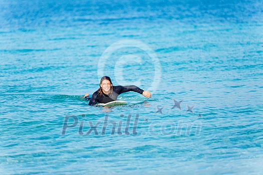 A young surfer with his board on the beach