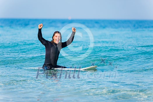 A young surfer with his board on the beach