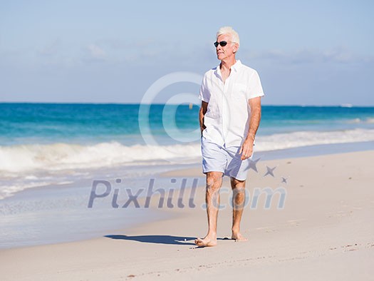 Man in white clothes on the beach on sunny day