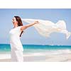 Woman in white clothes on the beach on sunny day