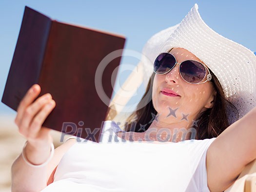 Woman in white clothes on the beach on sunny day