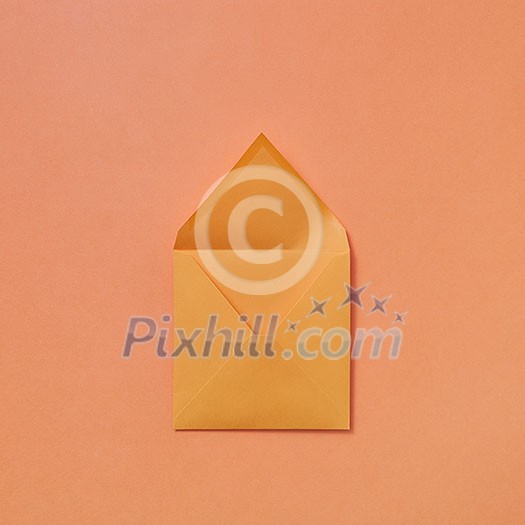 Mock up handmade open envelope for love letter on a light peach color background with copy space. Top view.