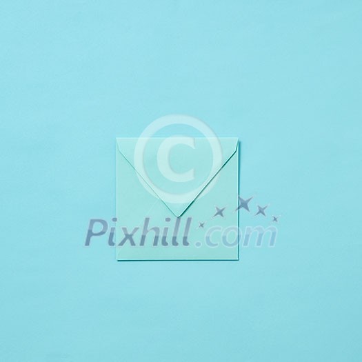 Mock up handmade envelope for greeting card or love letter on a pastel blue background with copy space. Top view.