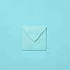 Mock up handmade envelope for greeting card or love letter on a pastel blue background with copy space. Top view.