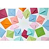 Greeting cards of handcraft multicolored envelopes frame on a light background with copy space.