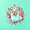 Congratulation composition of handmade envelope and pink roses flowers on a light turquoise background with copy space. Flat lay.