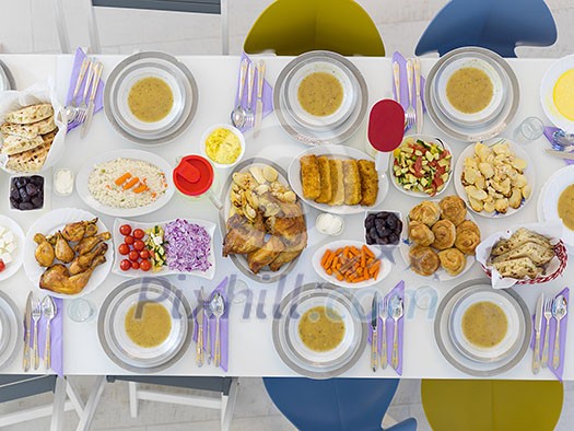 top view of beautiful decorated and served colorful food for iftar dinner on the white table during ramadan feast at home top view of beautiful decorated and served colorful food for iftar dinner on the white table during ramadan feast at home
