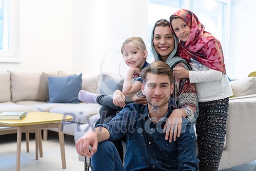 portrait of young happy modern muslim family before iftar dinner during ramadan feast at home