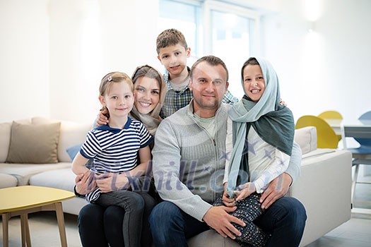 portrait of young happy modern muslim family before iftar dinner during ramadan feast at home