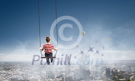 Cute little boy riding on swing. Mixed media Cute little boy riding on swing. Mixed media