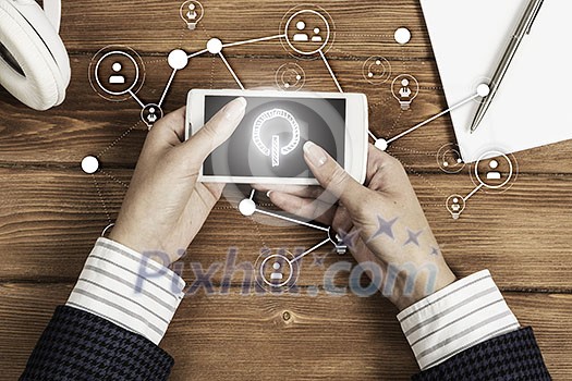 Top view of woman sitting at table and using smartphone