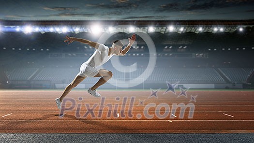 Athlete man running on racetrack at stadium. Mixed media