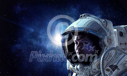 Astronaut man on space mission with starry sky on the background. Mixed media