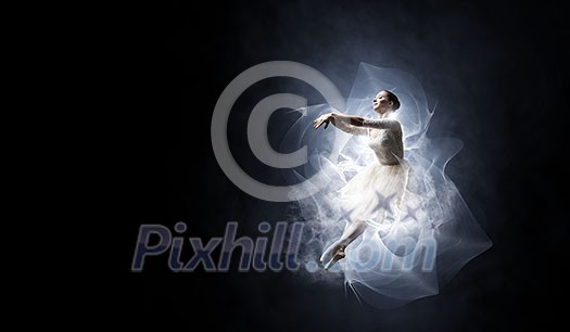 Elegant woman dancer in white dress against dark background