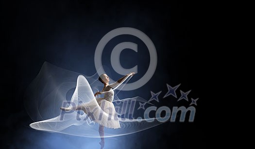 Elegant woman dancer in white dress against dark background