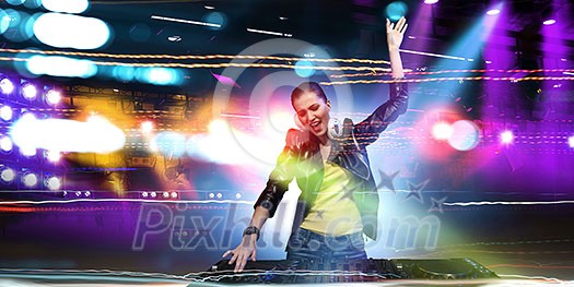 Young attractive woman dj in playing her music. Mixed media Young attractive woman dj in playing her music. Mixed media