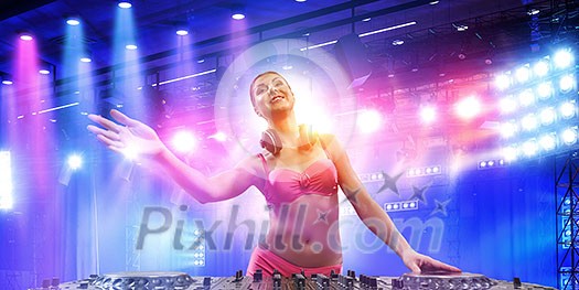 Young attractive dj woman in bikini playing her music. Mixed media
