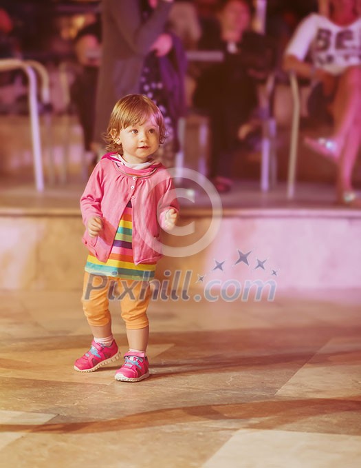 little cute girl carefully spending time while dancing in the kids disco