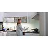 Pretty, young woman in her modern bright kitchen - healthy eating concept, household lifestyle concept