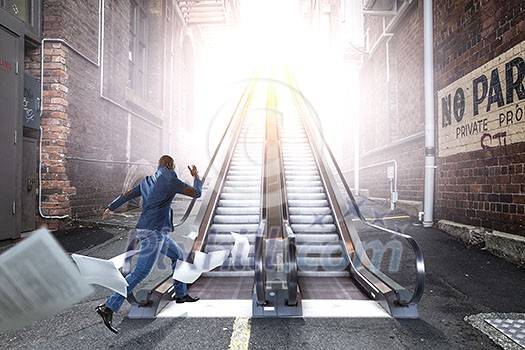 African man walking up on an escalator. Mixed media African man walking up on an escalator. Mixed media