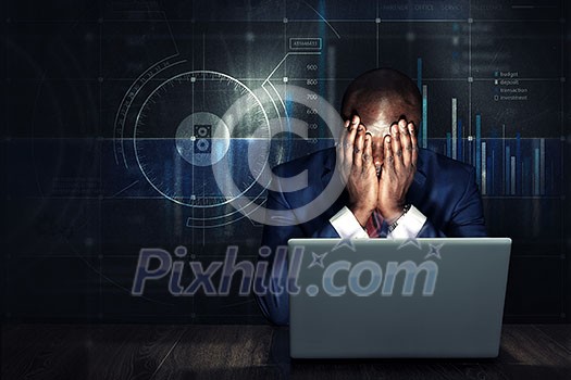 Handsome afroamerican businessman sitting at desk and working on laptop. Mixed media Handsome afroamerican businessman sitting at desk and working on laptop. Mixed media
