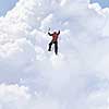 Alpinist man climbing white cloud high in sky. Mixed media