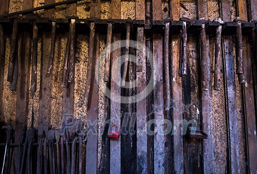 blacksmith tools hanging on a wooden wall blacksmith tools hanging on a wooden wall