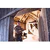 portrait of a miller in retro wooden watermill with old equipment