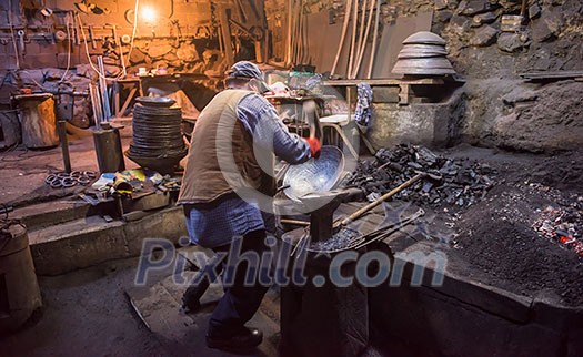 traditional blacksmith manually forging molten metal in smithy workshop. Blacksmith working metal with hammer in the forge traditional blacksmith manually forging molten metal in smithy workshop. Blacksmith working metal with hammer in the forge