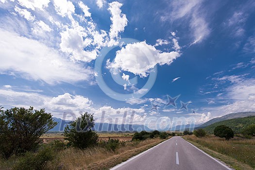 asphalt road in beautiful countryside on sunny summer day