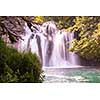 Amazing nature landscape, beautiful waterfall with sunlight in deep summer forest