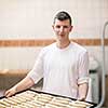 Semi finished products from dough  A young baker holding raw product of white dough ready for baking in the oven