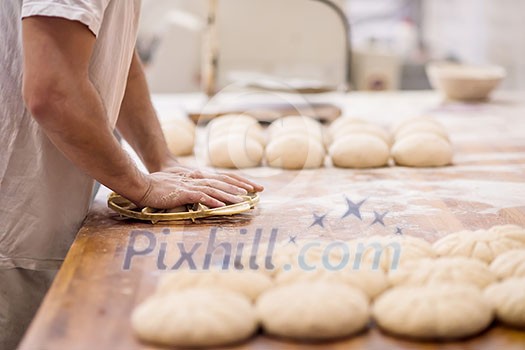 baker preparing the dough for products In a traditional bakery baker preparing the dough for products In a traditional bakery