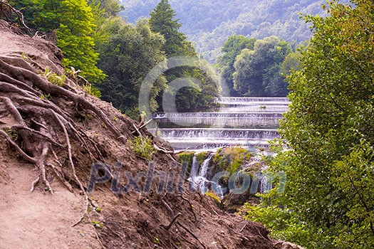 Amazing nature landscape, beautiful waterfall with sunlight in deep summer forest Amazing nature landscape, beautiful waterfall with sunlight in deep summer forest