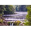 Amazing nature landscape, beautiful waterfall with sunlight in deep summer forest