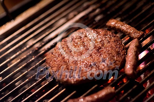 Assorted delicious grilled meat over the coals on barbecue Assorted delicious grilled meat over the coals on barbecue