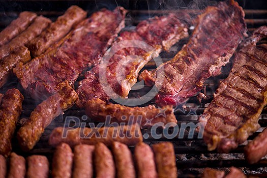 Assorted delicious grilled meat over the coals on barbecue Assorted delicious grilled meat over the coals on barbecue