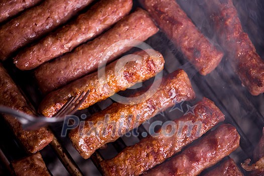Assorted delicious grilled meat over the coals on barbecue Assorted delicious grilled meat over the coals on barbecue