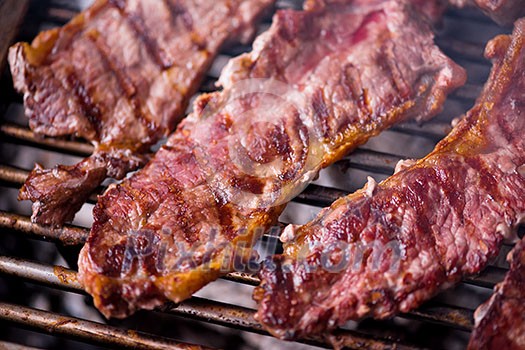 Assorted delicious grilled meat over the coals on barbecue Assorted delicious grilled meat over the coals on barbecue