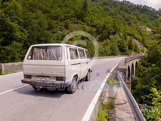 old white van on asphalt road in beautiful countryside at sunny summer day old white van on asphalt road in beautiful countryside at sunny summer day