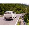 old white van on asphalt road in beautiful countryside at sunny summer day