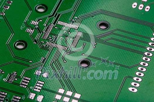 Printed green computer circuit board with many electrical components Printed green computer circuit board with many electrical components