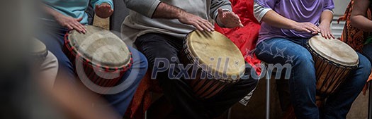 Group of people playing on drums - therapy by music Group of people playing on drums - therapy by music