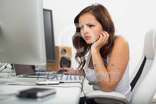 Woman working on a computer in a home office